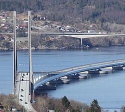 A concrete bridge over a large body of water