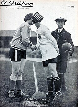 A cover of El Gráfico magazine depicts French footballer Carmen Pomiès, left, kissing English footballer Florrie Redford before a match in 1925.