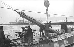 A torpedo is loaded into a U-Boat through a torpedo hatch.