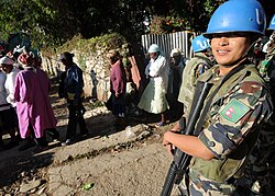 A Nepalese soldier on a peacekeeping deployment providing security at a rice distribution site in Haiti during 2010