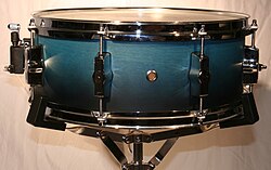 Snare drum on a modern light-duty snare drum stand.