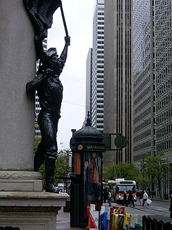 Another view of Market Street in downtown San Francisco, taken near the intersection with Montgomery Street, looking northeast toward the Ferry Building. The foreground bronze is entitled Admission Day, by Douglas Tilden.
