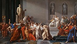 A painting showing a group of men attacking Julius Caesar, some of them armed with knives. Caesar, wearing a laurel crown, is seated with an arm outstretched towards his attackers. In the background, a crowd looks on in shock.