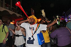 A man sounding a vuvuzela