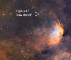 The picture shows a curved bow shock structure resulting from the Cygnus X-1 accretion disk jet interacting with a dense interstellar cloud