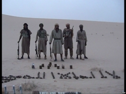 Al-Qaeda in Maghreb members pose with weapons spelling out the Shahada.