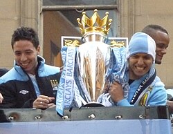 Agüero (right) and Samir Nasri parade the Premier League trophy, May 2012