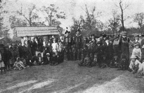 Keetoowah Nighthawk Society leaders Redbird Smith and Bluford Sixkiller instructing children in Cherokee rituals, from Starr (1921).[1]
