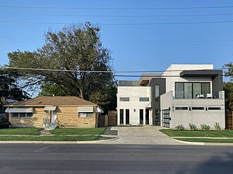 Gentrification with a typical ranch house side by side with a modern house in Dallas, Texas, in 2020