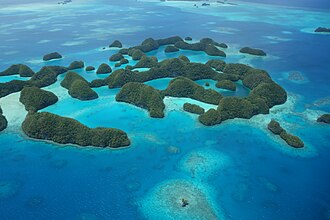 Aerial view of small forested coral islands and reefs in Palau.