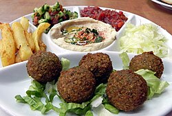 A meal including falafel, hummus, French fries and Israeli salad
