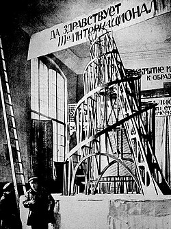 Vladimir Tatlin next to a model of Tatlin's Tower, 1920