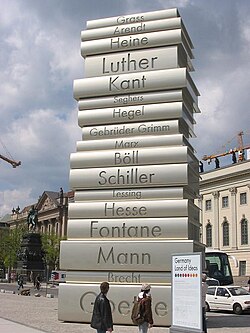 Sculpture in Berlin depicting a stack of books on which are inscribed the names of great writers: Goethe; Brecht; Mann; Fontane; Hesse; Lessing; Schiller; Böll; Marx; Brothers Grimm; Hegel; Seghers; Kant; Luther; Heine; Arendt; Grass