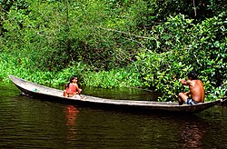 A Warao family traveling in their canoe in Venezuela