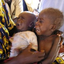 Laure Souley holds her three-year-old daughter and an infant son at a MSF aide center during the 2005 famine, Maradi Niger