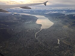 The city stretches on both sides of the Limmat, which flows out of Lake Zurich. The Alps can be seen from the city centre, background to the lake.