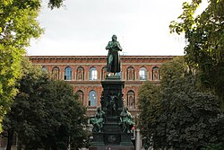A statue of Friedrich Schiller in front of the Academy of Fine Arts