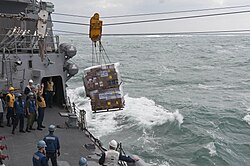 USS Mustin receives supplies at sea