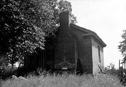 The detached brick kitchen building at the former Lowry Plantation outside of Marion, Alabama. The main house is wood-frame with brick columns and piers.