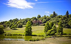 The view of the house from across the lower lake