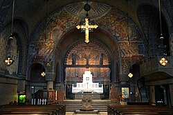 The chancel of the Church of the Revelation, an Evangelical-Lutheran parish of the Church of Sweden in the locality of Saltsjöbaden. The rood screen and chancel arch are visible from the nave.