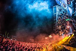 An EDM festival in 2013 in Plainfeld, Austria with over 100,000 attendees,[204] exhibiting the large crowds and dramatic lighting common at such events since the early 2000s.[3]
