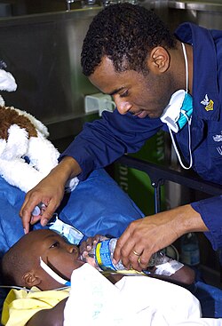 A Haitian child is treated aboard a hospital ship.