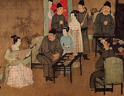 A Chinese painting of a group of men and women reveling at a banquet