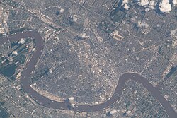 View of Uptown and vicinity from the International Space Station on June 28, 2022. Many streets run perpendicular to the river.