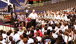 Popovich, with Secretary of Defense William Cohen and Spurs player David Robinson, speaks to Junior ROTC cadets from local high schools (2000).