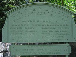 Sign near the current bridge salvaged from its original 1889 counterpart
