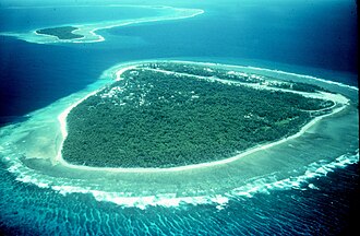 Island (Falalop) with fringing reef off Yap, Micronesia. Coral reefs are dying around the world.[154]