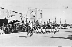 Parade of Italian askaris in front of King Victor Emanuel III and Governor Rodolfo Graziani during the King's visit in Italian Cyrenaica in February 1932