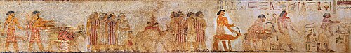 Egyptian depiction of the visit of Western Asiatics in colorful garments, labeled as Aamu. The painting is from the tomb of a 12th dynasty official Khnumhotep II at Beni Hasan, and dated to c. 1900 BCE. Their nearest Biblical contemporaries were the earliest of Hebrews, such as Abraham and Joseph.[93][94][95][96]