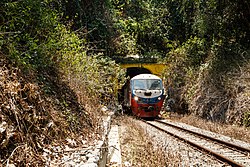 Sabah State Railway train passing through a tunnel of the Western Line in Pengalat Besar, Papar District