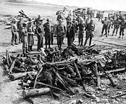 Allied commander-in-chief Dwight D. Eisenhower tours Ohrdruf concentration camp, May 1945.