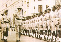 Brigadier James Sinclair, Earl of Caithness inspecting a guard of honour wearing khaki drill.