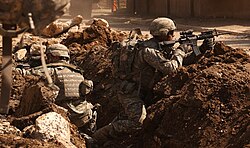 US soldiers take cover during a firefight with insurgents in the Al Doura section of Baghdad, 7 March 2007.