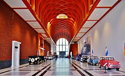 Classic cars displayed at an automotive museum, which could be considered both a history and technology museum