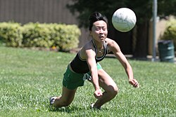A volleyball player preparing for a dig
