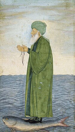 Al-Khidr, the Verdant One, standing on a large fish swimming on the surface of water. The Islamic mid-17th century Mughal painting has a frame with floral and foliated scrolling patterns and has a ground decorated with flowers, with pink lilies and red poppies
