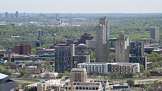 High-rise buildings in Minneapolis's Cedar-Riverside neighborhood, with the Downtown Saint Paul skyline visible in the background ten miles away. Minneapolis' city limits border those of Saint Paul, the capital of Minnesota. This gave birth to the nickname of the region, the "Twin Cities" metropolitan area.