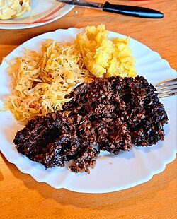 Blood sausage served with sauerkraut and "restani krumpir" in Hrvatsko Zagorje