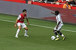Dyer attempts to get past Mikel Arteta