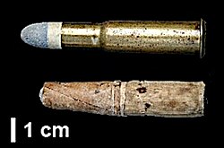 A metallic brass cartridge for a Fusil Gras mle 1874 and a paper cartridge for a Chassepot rifle. The brass cartridge avoided the smoke and ashes of the self-consuming paper cartridge.