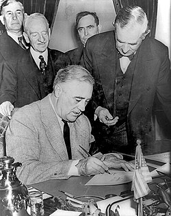US President Franklin D. Roosevelt signs a declaration of war against Nazi Germany on 11 December 1941.