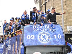 Drogba (front, second from left) on a street parade with Chelsea after winning the league and cup double in May 2010