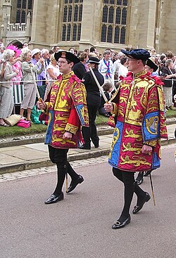 Two pursuivants wearing tabards at the Garter Service, Windsor Castle, 2006: Peter O'Donoghue, Bluemantle Pursuivant (left), and Alastair Bruce of Crionaich, Fitzalan Pursuivant Extraordinary (right)