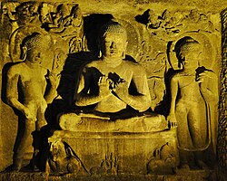 Buddha statue on the upper floor of Ajanta Cave No. 6. These caves are associated with the Mahāsāṃghika school.[24]