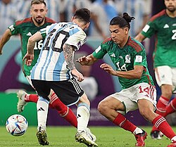Messi facing off against Érick Gutiérrez of Mexico in the 2022 FIFA World Cup group stage